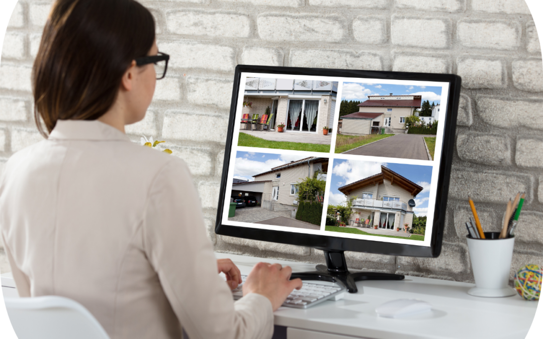 Real estate agent browsing property listings on a computer screen, reviewing multiple home options in a modern office.